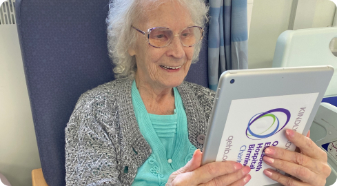 Gladys using an iPad provided by UHB Charity