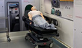 Image: Mannequin of patient lying on a bed in an ambulance mock-up
