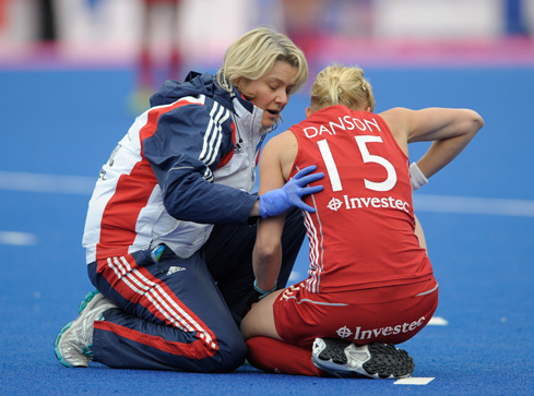 QEHB physiotherapist Emma Batchelor attends to Alex Danson during a GB women's hockey match. Photograph: Ady Kerry/GB Hockey.