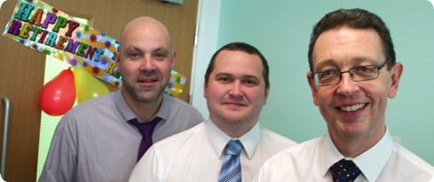 Image (L-R): colleagues Martin Roch and Dan Kearns say farewell to Chris Gaskin