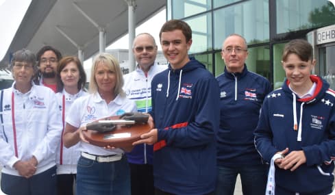image: Lisa Wilson with Tom’s Baton and members of Birmingham Adult Transplant Sport Team