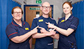 Image: Three staff members sporting the new yellow name badges