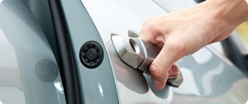Image: car door handle and persons hand