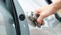 Image: car door handle and persons hand