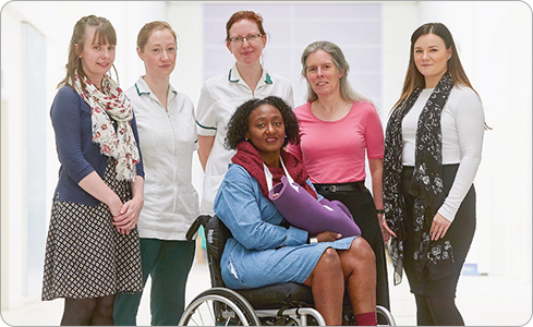 Patient Tracy Scantlebury (seated front) with staff from services who helped her