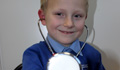 Photo: George of St Kenelm's Primary School tries out a stethoscope