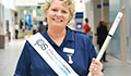 Deputy Chief Nurse Michele Owen with Infection Prevention Society torch